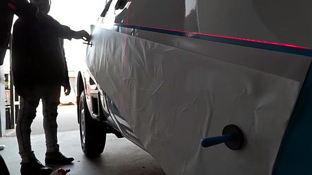 Red laser line guiding am.co.za vinyl on truck (SKU ask)