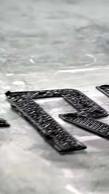 Raised black channel letters on green bed (SKU ask)