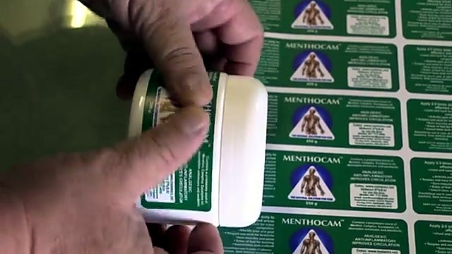 Applying MENTHOCAM circular label to white tub lid (SKU ask)