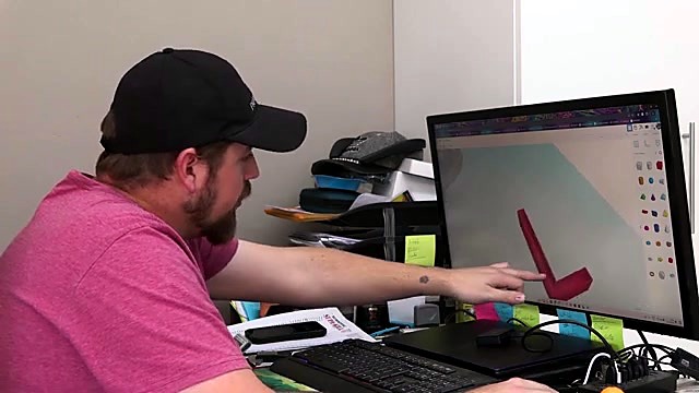 Presenter points at TinkerCAD L-channel model (SKU ask)