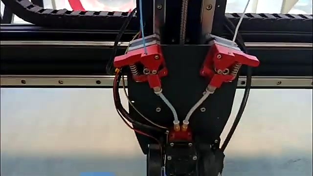 Dual red extruder heads close-up (SKU ask)