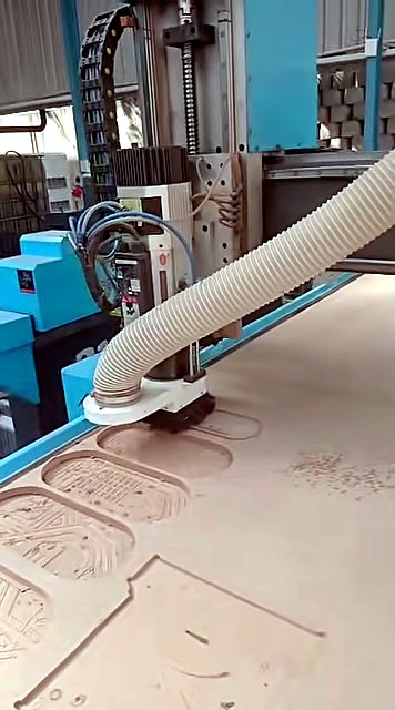 ATC CNC cutting oval patterned pockets; dust hood visible (SKU ask)