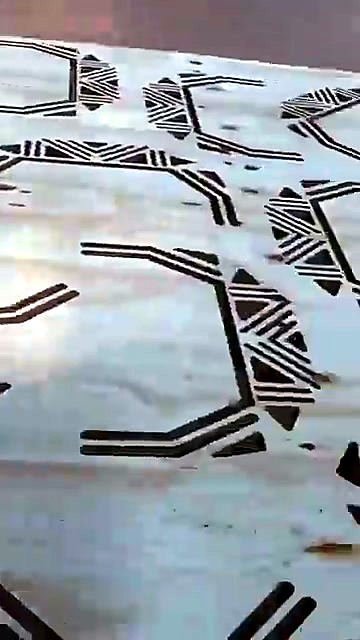 CNC-routed geometric pattern on wood panel
