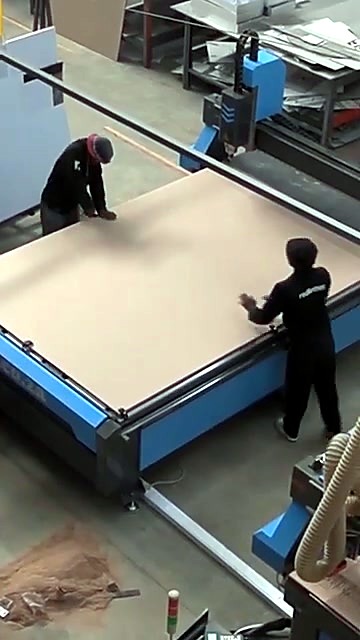Operators load large board onto EasyRoute ATC bed (SKU ask)