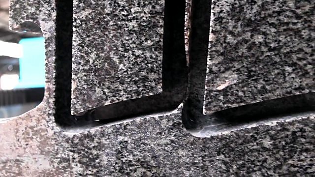 Clean granite cut-edge macro after stone routing (SKU ask)