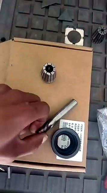 ER25 collet, collet nut and 12mm end mill laid out before installing on an EasyRoute CNC router