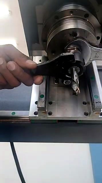 Spanner tightening the ER25 collet nut to lock the 12mm bit in the EasyRoute CNC router spindle