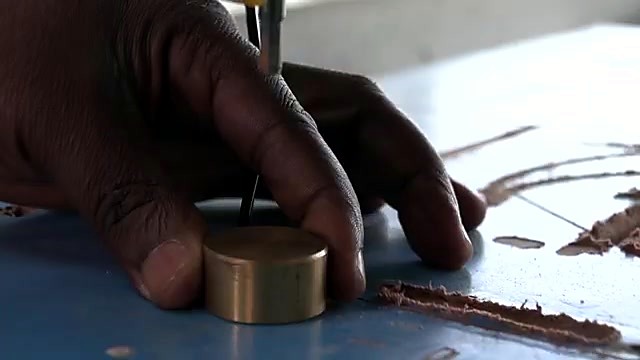 Brass floating-tool touch-off on blue bed (SKU ask)