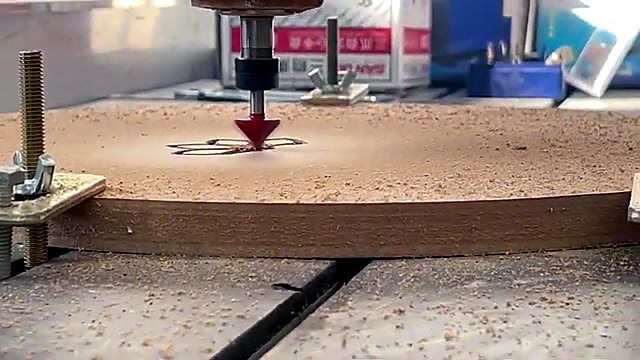 Red V-bit carving mandala in MDF on T-slot (SKU ask)