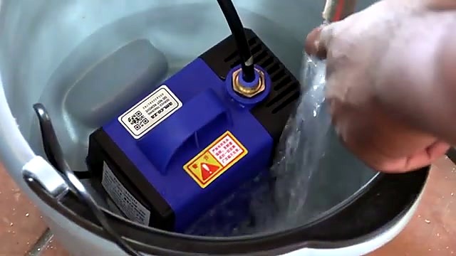 Blue submersible water pump in bucket (SKU ask)