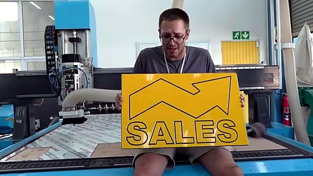Finished yellow two-tone SALES arrow sign with machine (SKU ask)