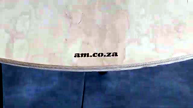 CLEAR am.co.za edge brand on plywood table rim (SKU ask)
