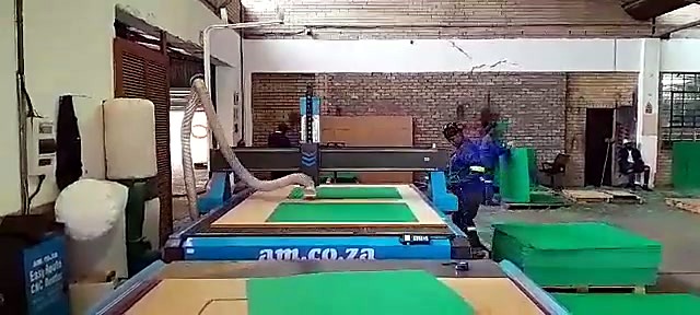 Operator loads green foam onto branded vacuum bed (SKU ask)