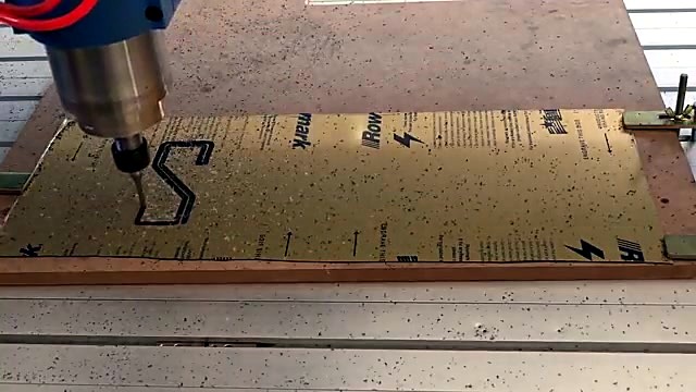 Spindle engraving S into gold/black Rowmark (SKU ask)