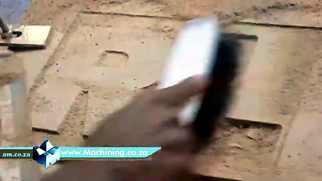 Brush clearing dust revealing finished R carve (SKU ask)