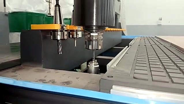 ATC spindle collecting a tool from the yellow tool forks