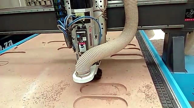 9kW ATC spindle with brush dust hood and hose cutting a pocket in MDF