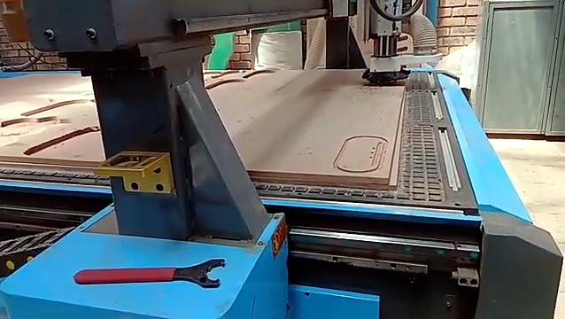ATC spindle cutting wood with dust on tracks
