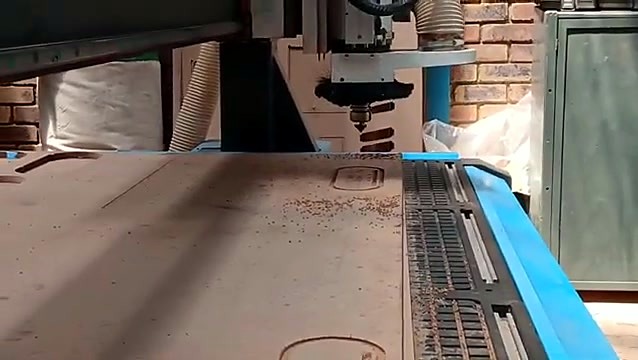 Close-up spindle carving into wood sheet