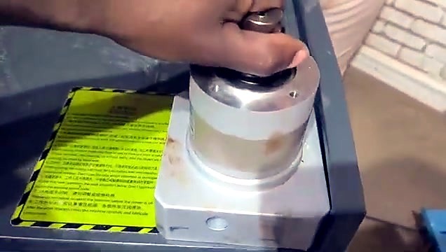 Spindle manual adjust beside yellow warning label