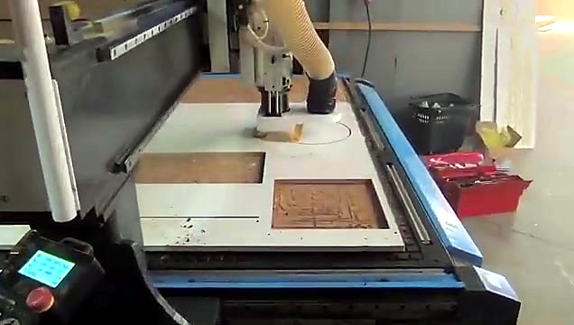 Gantry cutting white sheet with dust extraction hose
