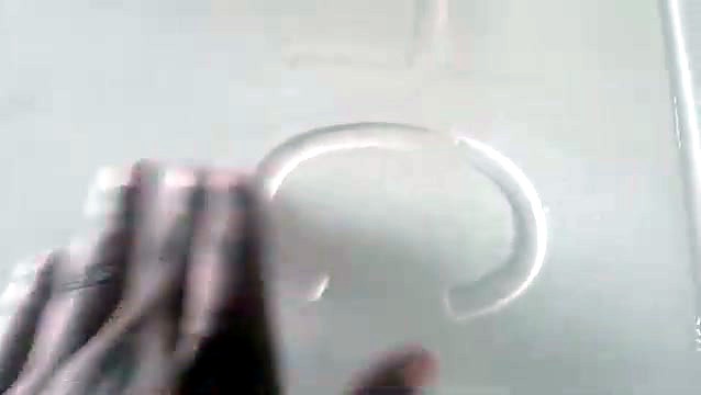 Hand on a carved curved shape in the quartz slab after machining