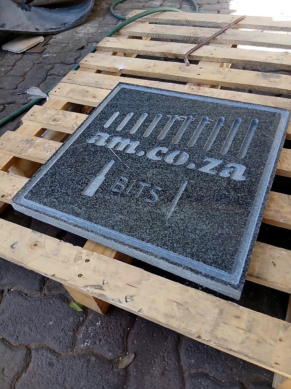 R-1325W/55 stone router sample: am.co.za BITS logo engraved in granite plaque (staff still)