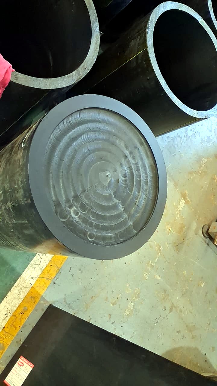 R-2030K/55L EasyRoute: CNC-machined stepped disc fitted as an end cap into large black plastic pipe (application, staff still)