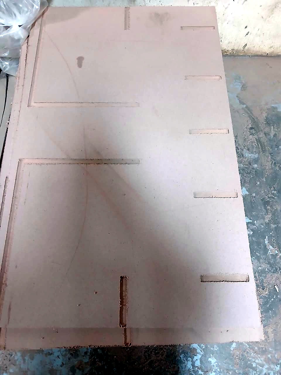 R-2030K/55L EasyRoute: full MDF sheet machined on the CNC router - recessed panel pockets, straight grooves and through-slots (cut sample, staff still)