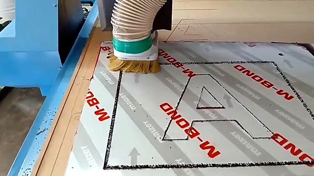 Letter A toolpath mid-cut on M-BOND ACM (SKU ask)