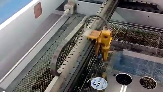 CO2 laser head over acrylic sheet