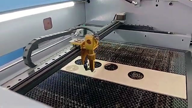 CO2 laser head over wooden board