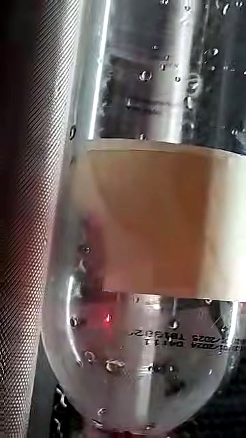 Red-dot on PET bottle — rotary/cylindrical marking setup (SKU ask)