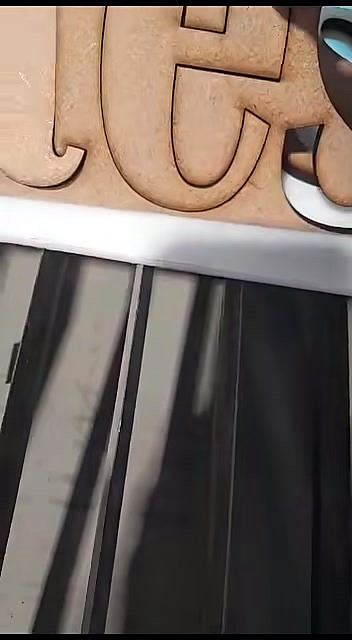 Cut letters resting on knife-slat bed (SKU ask)
