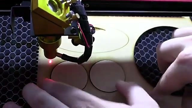 Hands lift cut coin blanks from honeycomb (SKU ask)