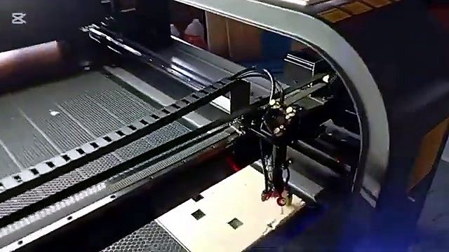 Gantry cutting square holes; smoke visible (SKU ask)