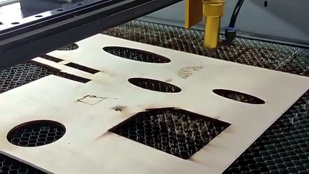 Basswood sheet with cut oval and square holes on the honeycomb bed