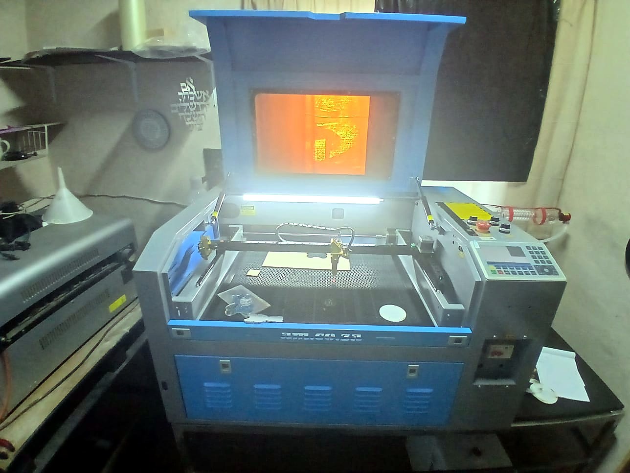 LC-6040L/80P TruCUT desktop: lid open showing honeycomb bed, gold laser head and blue front bar (staff still)