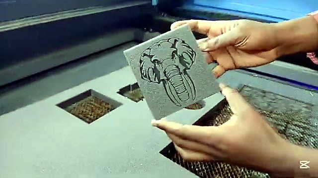 Hands hold finished foam elephant tile (SKU ask)