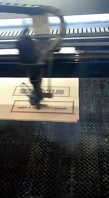 Gantry laser head engraving wood; smoke at contact (SKU ask)