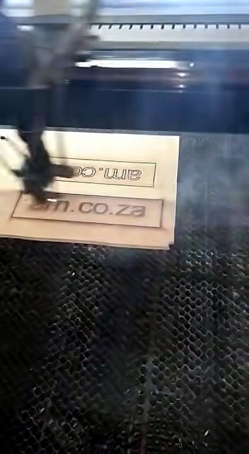 Engrave progress am.co.za branding on wood sheet (SKU ask)