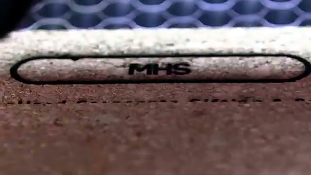 Yellow laser head engraving MHS logo on cork (SKU ask)