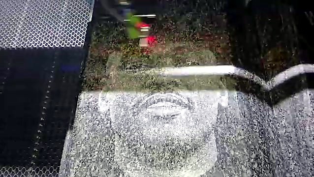 Laser head etching portrait on black granite (SKU ask)