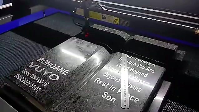 Open-book granite memorial overview mid-engrave (SKU ask)