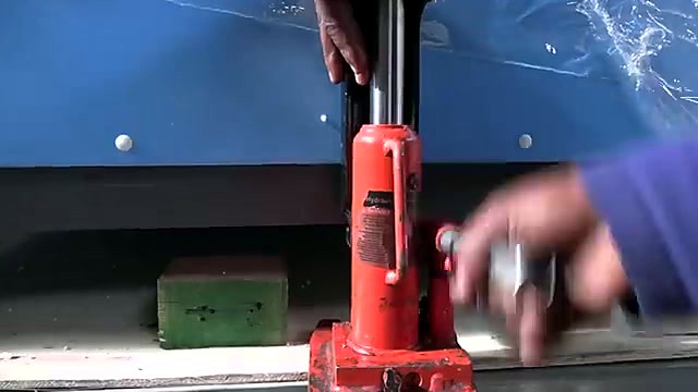 Red bottle jack lifting cabinet frame (SKU ask)