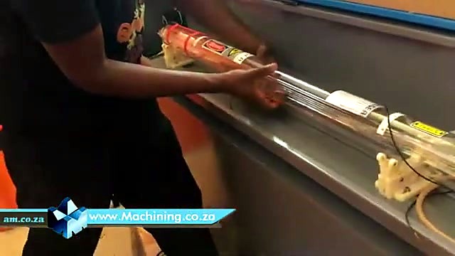 Technician installing glass CO2 tube (SKU ask)