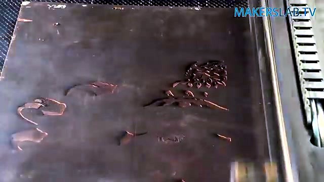 Intricate crest parts laid out on laser bed (SKU ask)