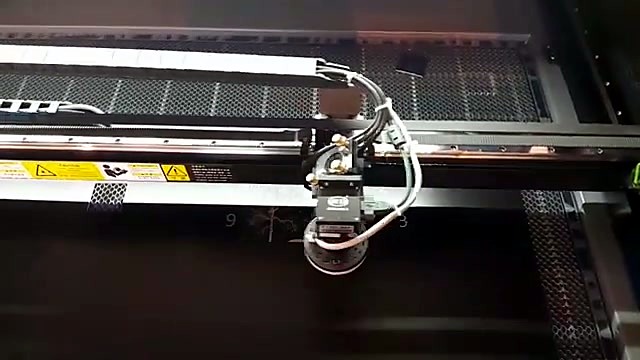 Gantry mid-pass over black sheet interior (SKU ask)