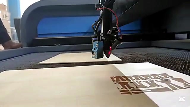 Head engraves AM.CO.ZA on plywood (SKU ask)