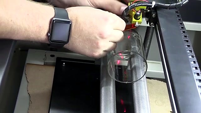 Hands loading clear glass onto two-roller rotary (SKU ask)